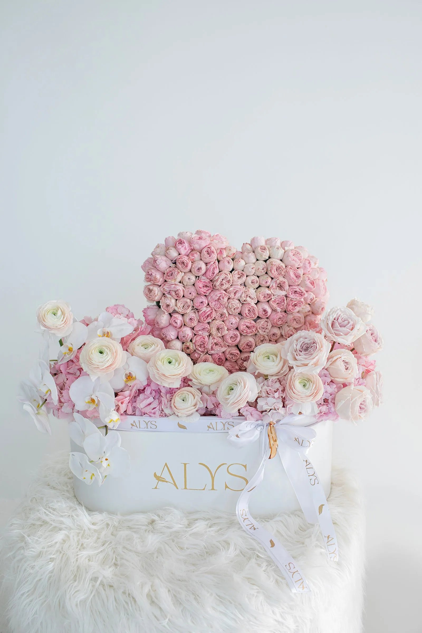Heart-shaped flower box with peony roses, orchids and ranunculus by ALys Studio Dubai