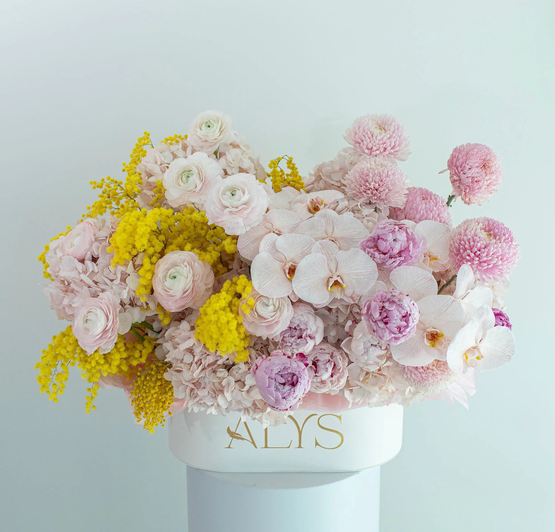 Oval spring box of ranunculus, hydrangea, peonies and orchids by ALys Studio Dubai