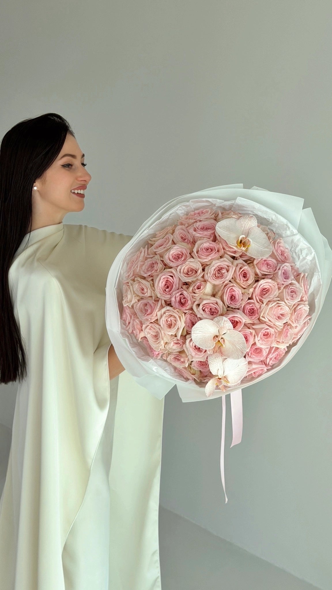 Bouquet of pink O'Hara roses with two orchid stems by ALys Studio Dubai