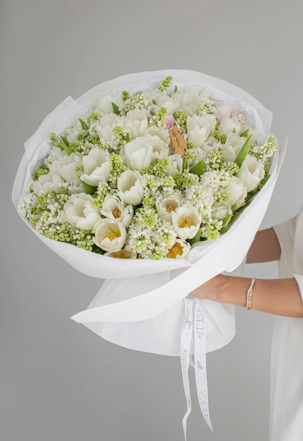 Spring bouquet of lilac branches and tulips by ALys Studio Dubai