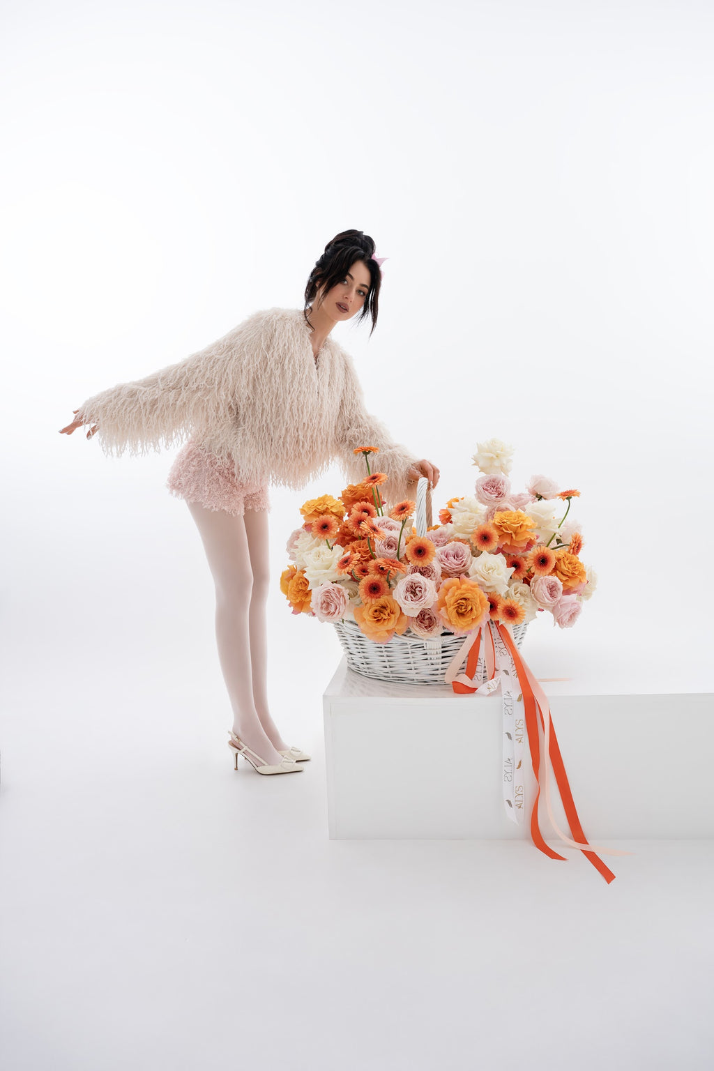 A vibrant basket of pink peony roses, gerberas, and white roses