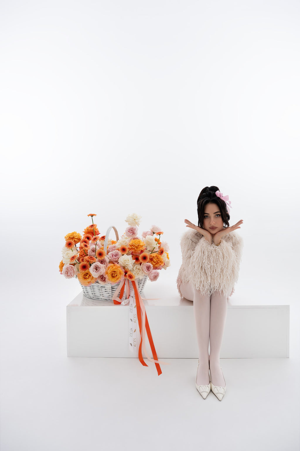 A vibrant basket of pink peony roses, gerberas, and white roses